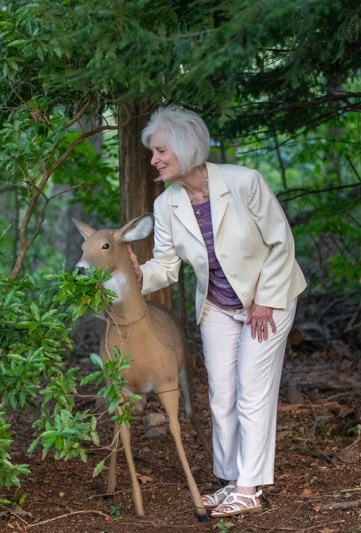 Joan with deer decluttering backyard